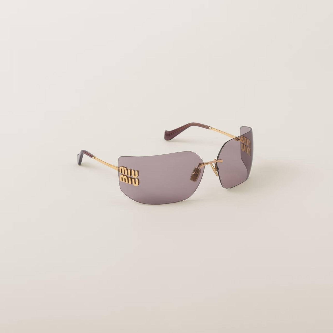 Image of Miu Miu wide screen sunglasses with gold metal frame and frameless curved lenses.