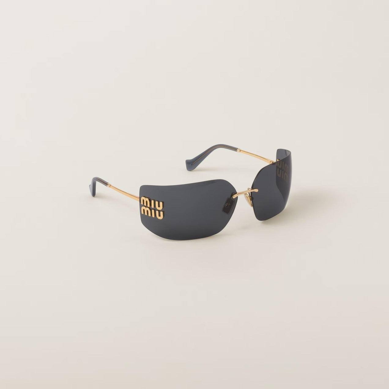 Image of Miu Miu wide-screen gold metal sunglasses with frameless curved lenses and adjustable nose pads.