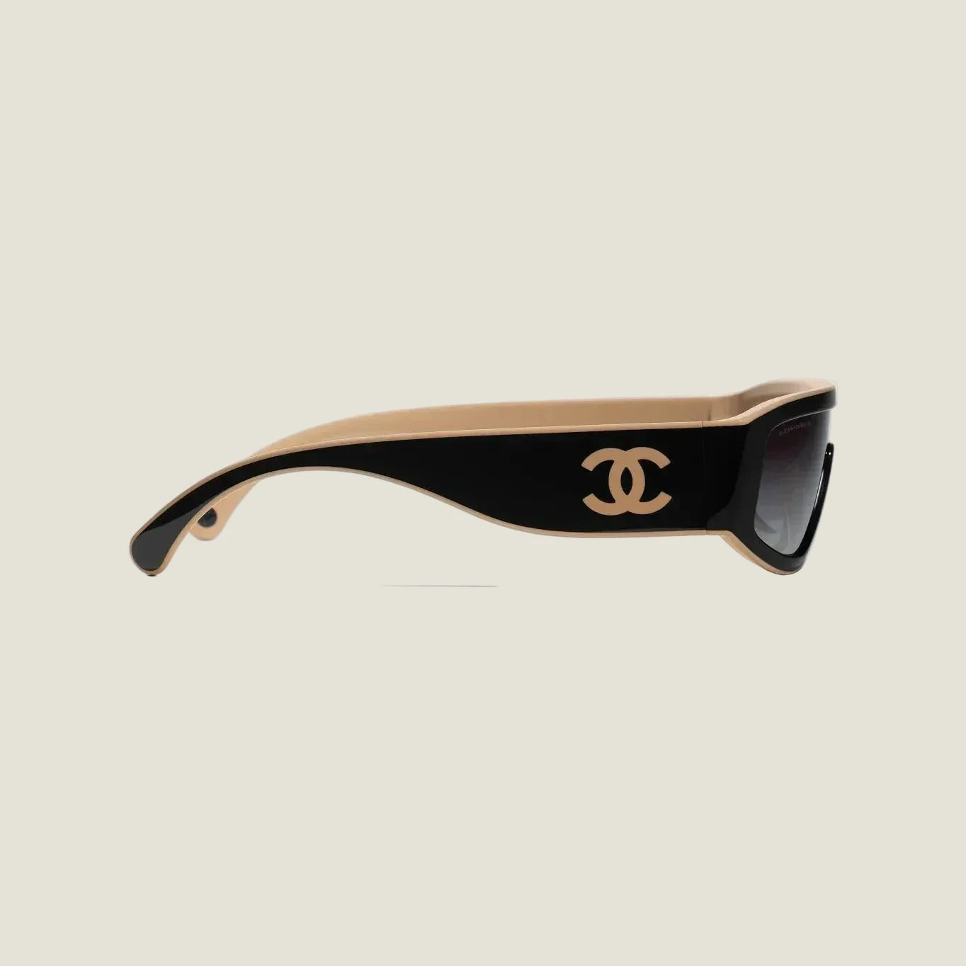 Black and brown CHANEL sunglasses with plastic frame and adjustable nose pads, offering 100% UVA/UVB protection.