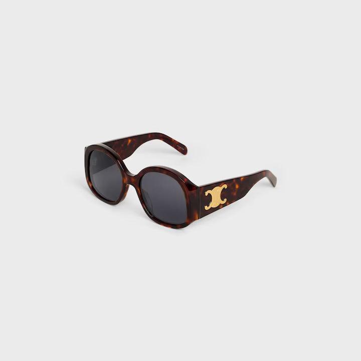 Image of Celine sunglasses with logo, featuring tortoiseshell frame and dark lenses.