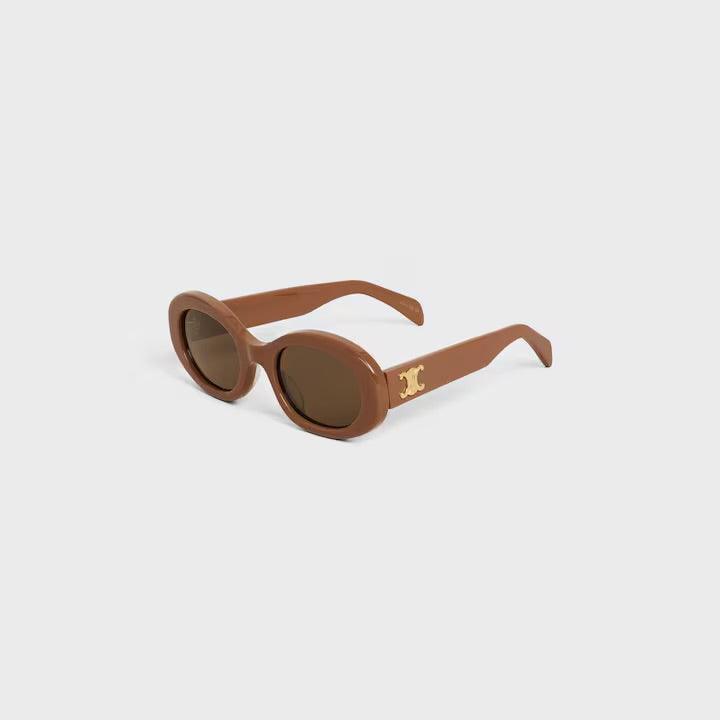 Celine sunglasses with brown round frames and tinted lenses featuring the logo on the temples.