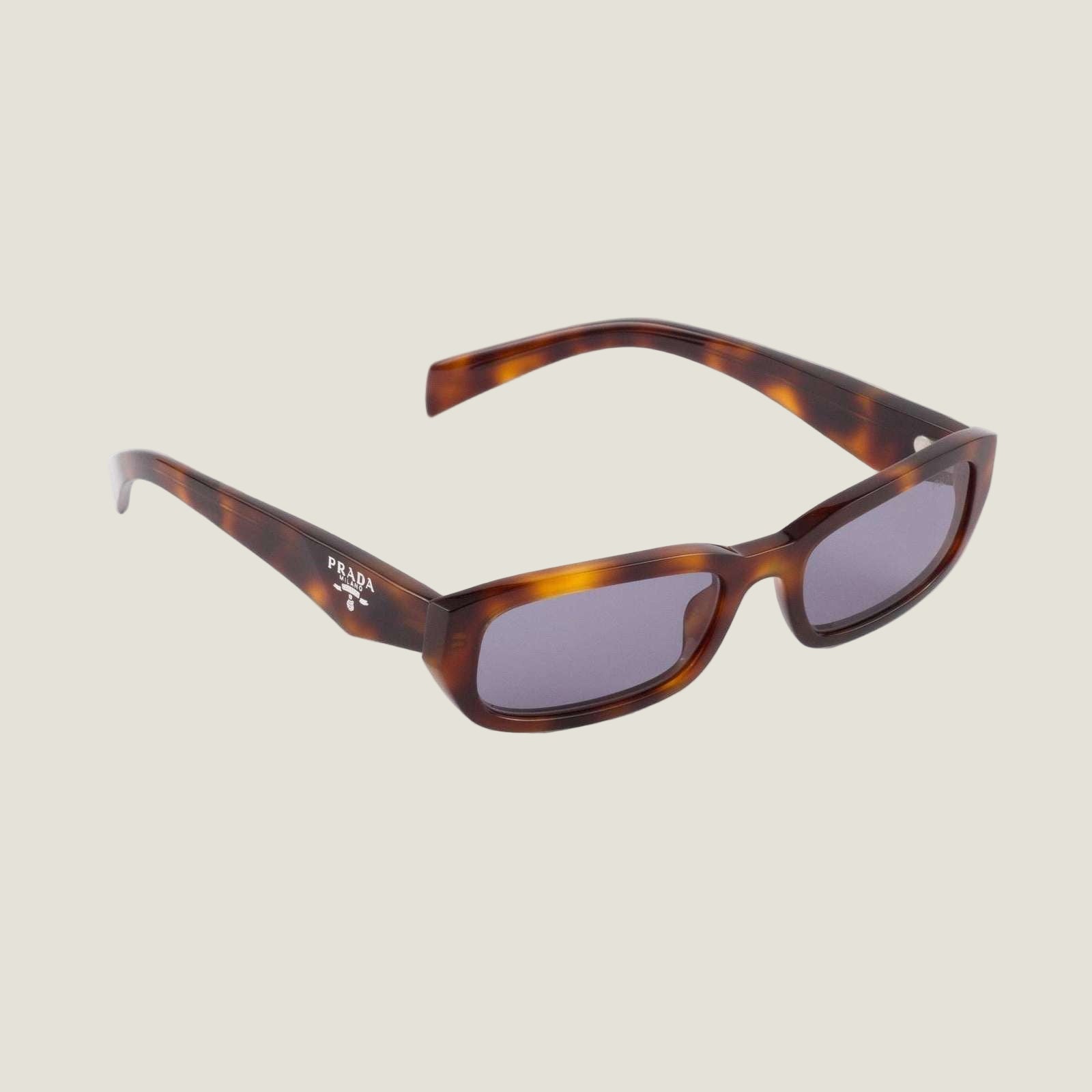 Luxury Prada sunglasses with bold geometric frames and prominent logo.
