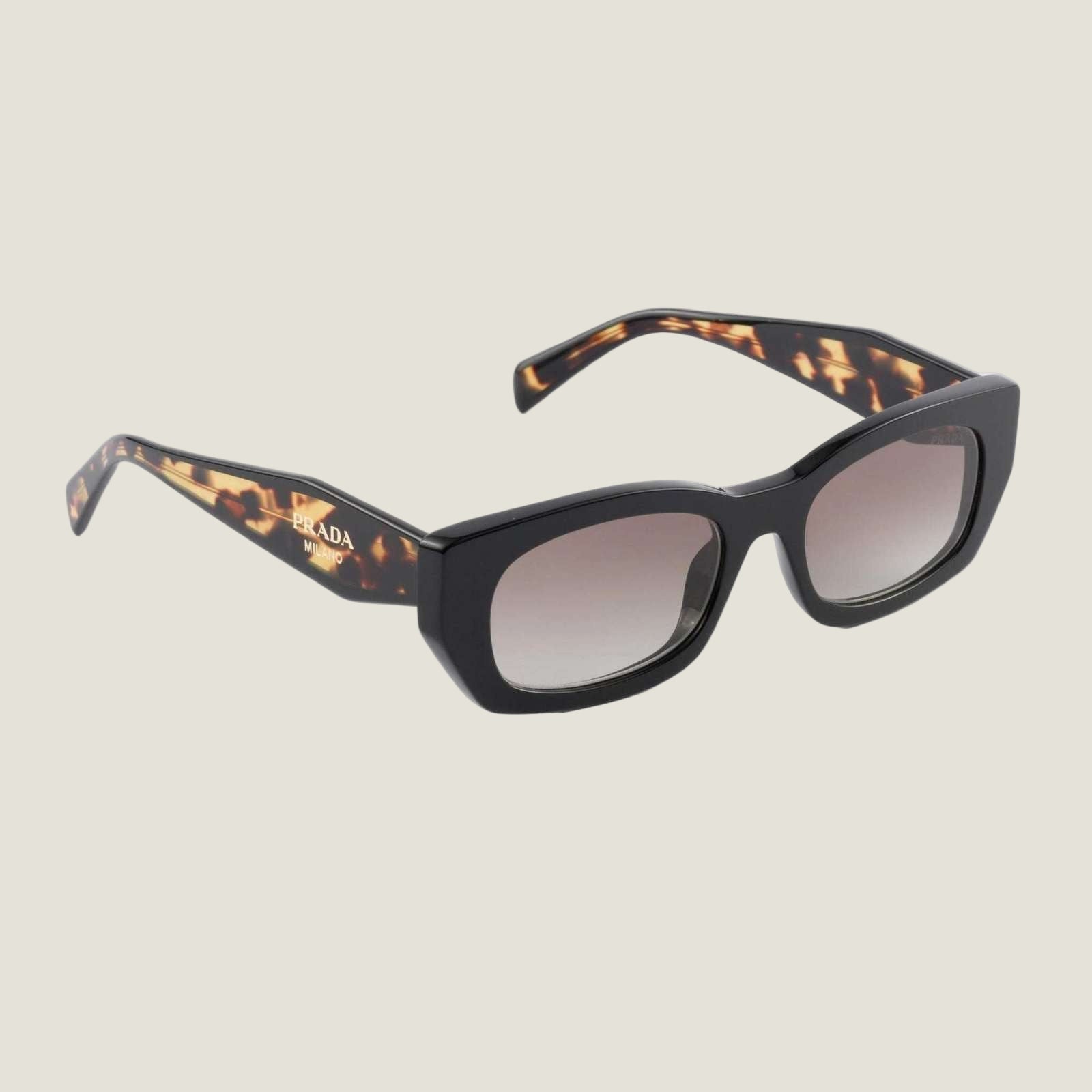 Prada designer sunglasses with bold logo and geometric frames, tortoiseshell pattern.