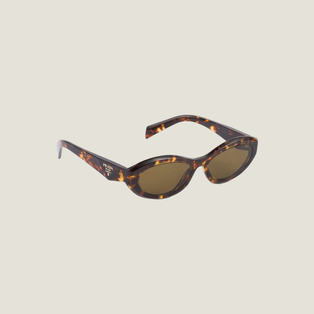 Luxury Prada sunglasses with bold geometric frames and logo detailing.