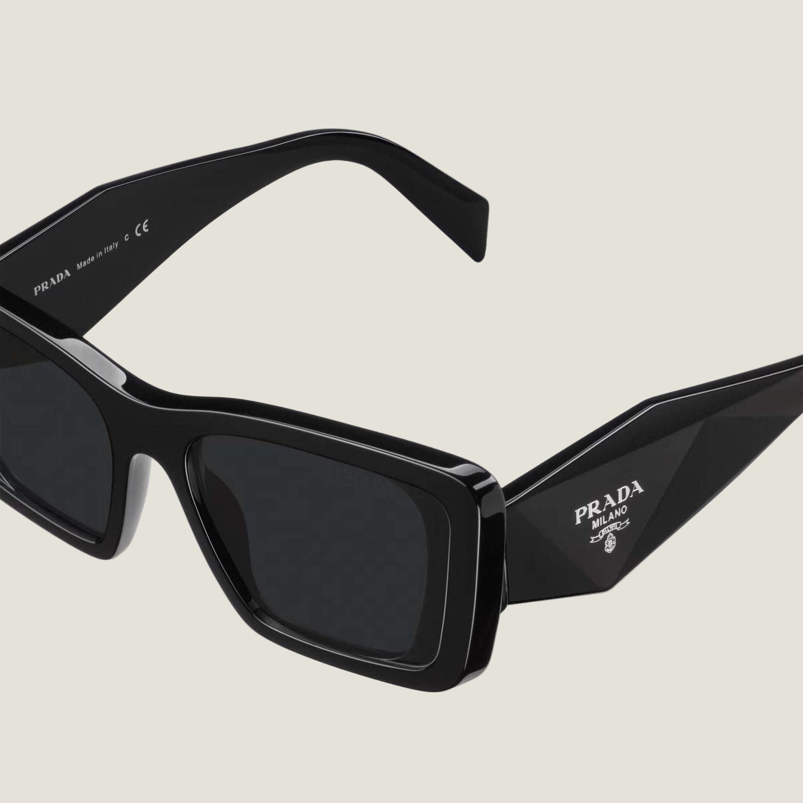 Image of PRADA logo sunglasses with geometric frames and bold design.
