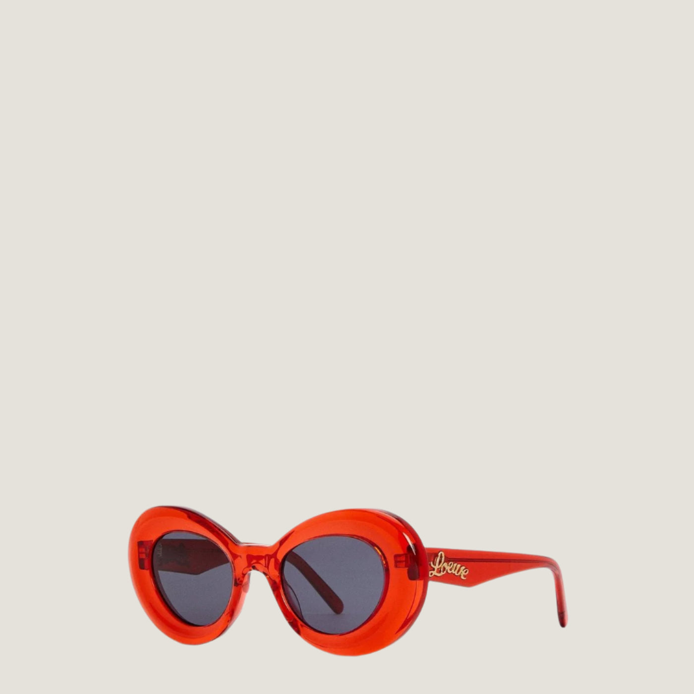 Image of Red LOEWE sunglasses with geometric frames and UV400 protection.