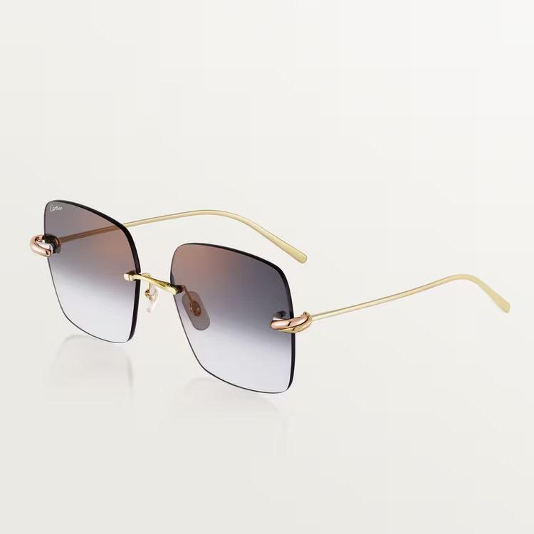 Cartier luxury sunglasses with gold metal frame and UV400 lenses.