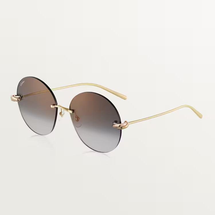 Elegant Cartier sunglasses with gold metal frame and UV400 lenses.