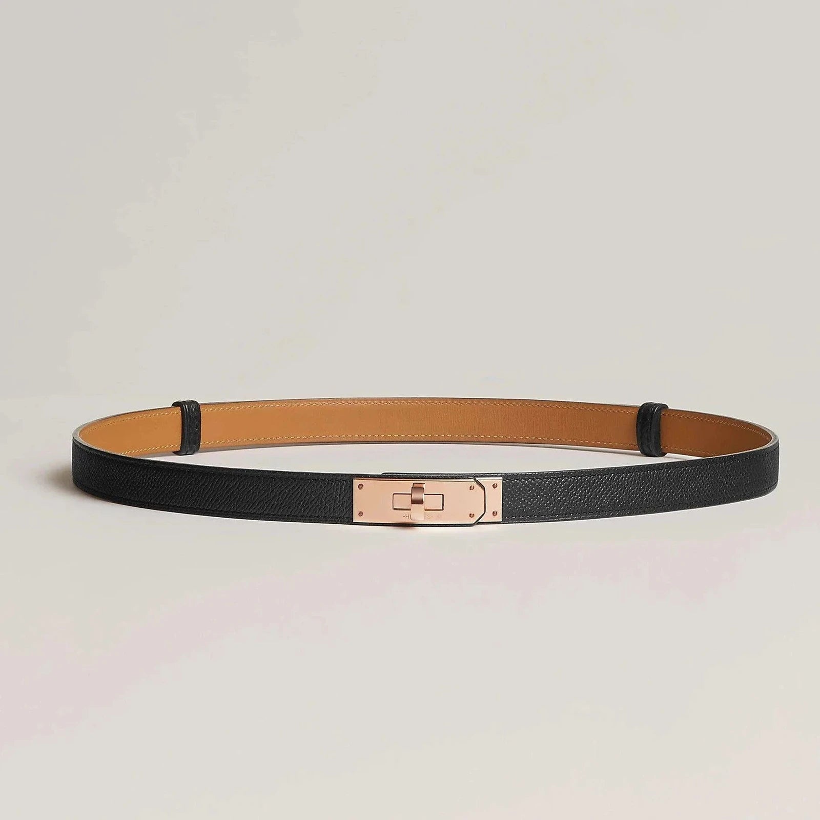 Image of Hermes Kelly leather belt with minimalist metallic buckle in black.