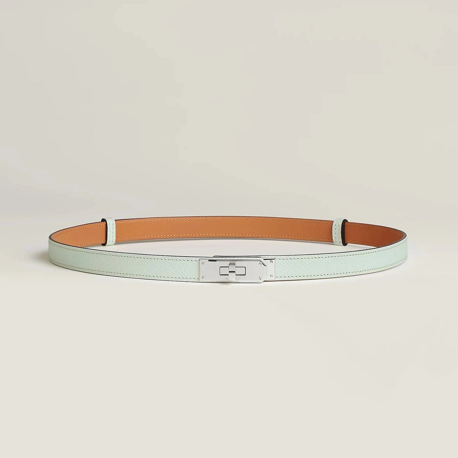 Hermes Kelly leather belt with silver buckle, luxury fashion accessory.