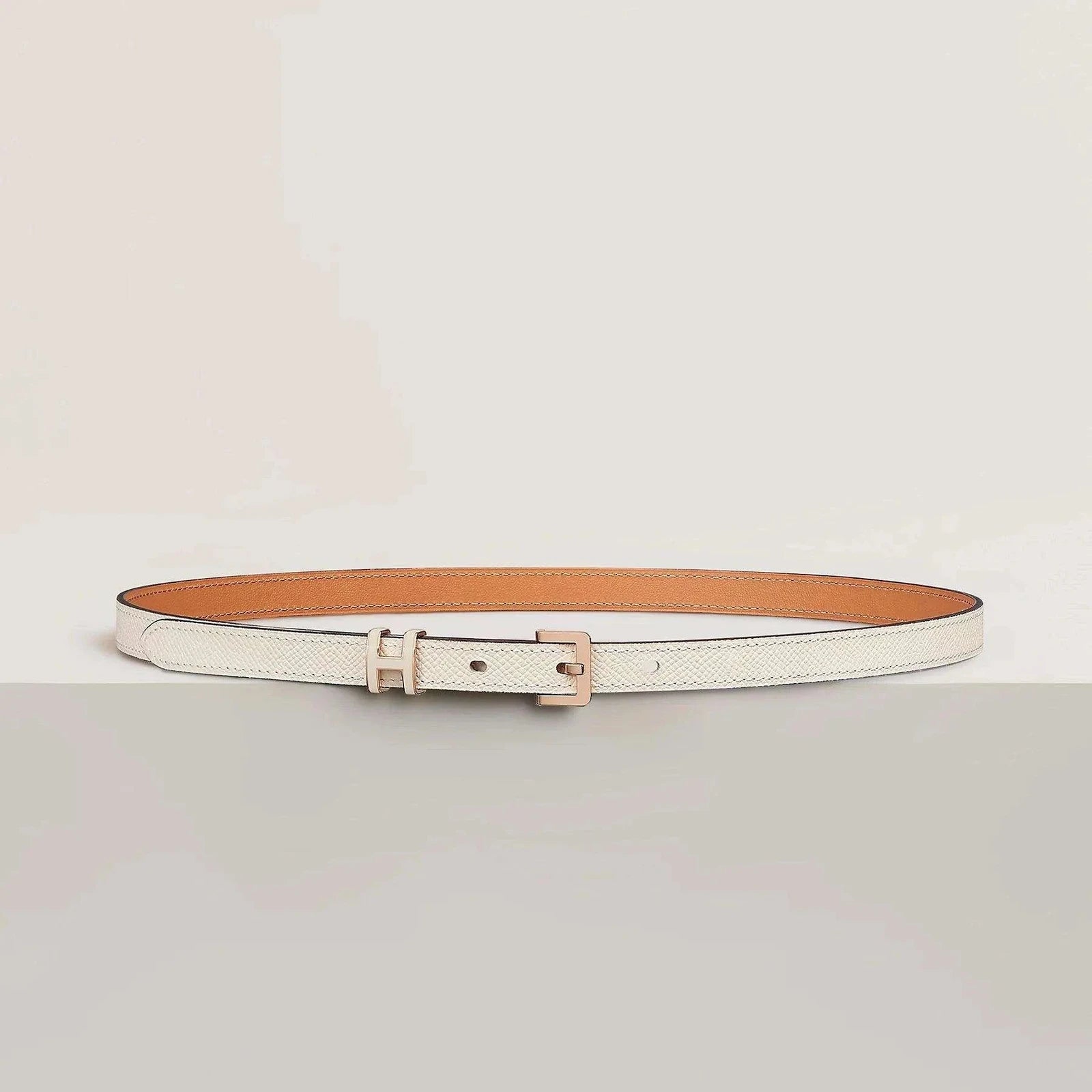 Image of Luxury Hermes leather belt with minimalist design and elegant metallic buckle, showcasing premium craftsmanship.