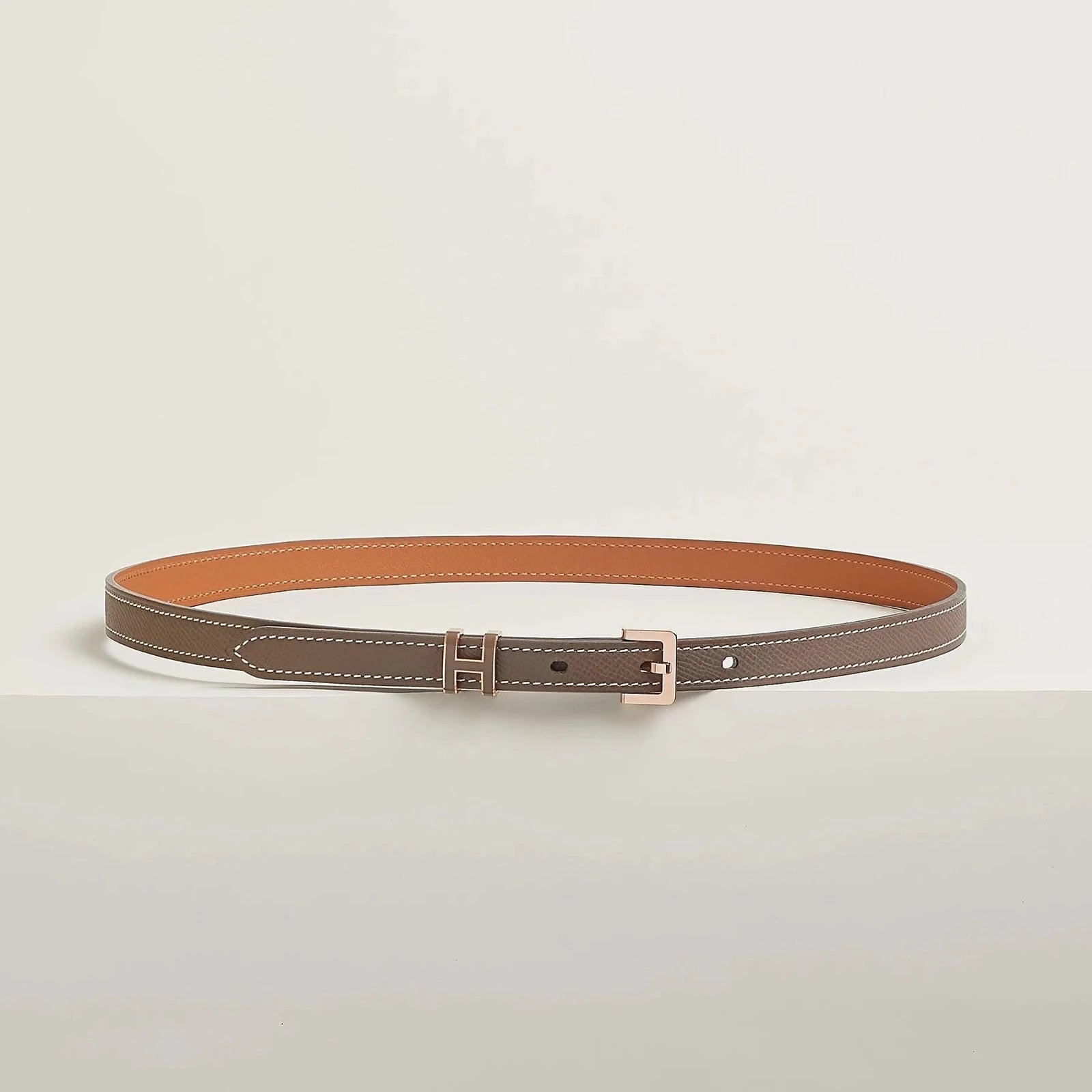 Image of Hermes belt in premium leather with elegant metallic buckle.