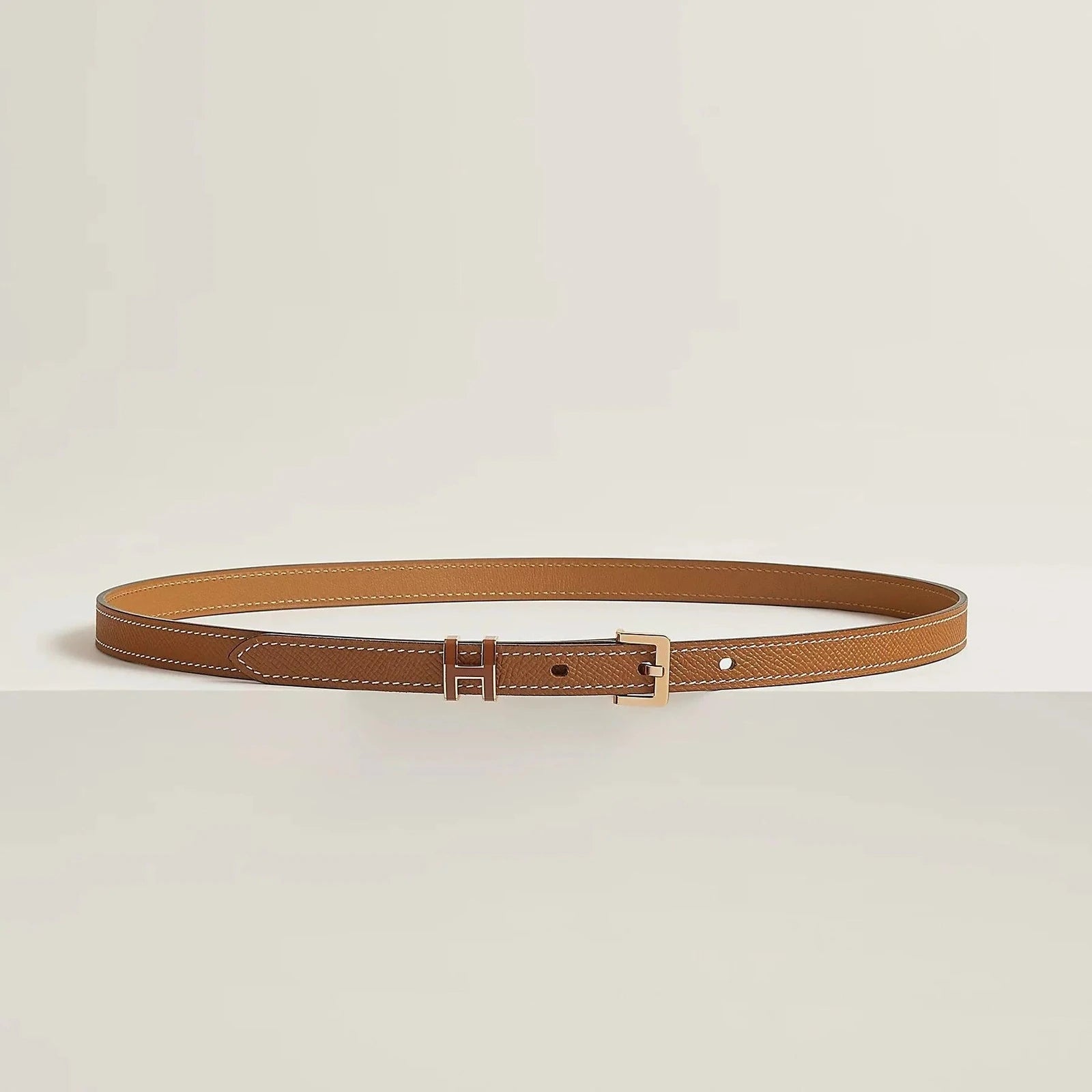 Image of Premium leather Hermes belt with elegant metallic buckle, showcasing minimalist design and luxury craftsmanship.