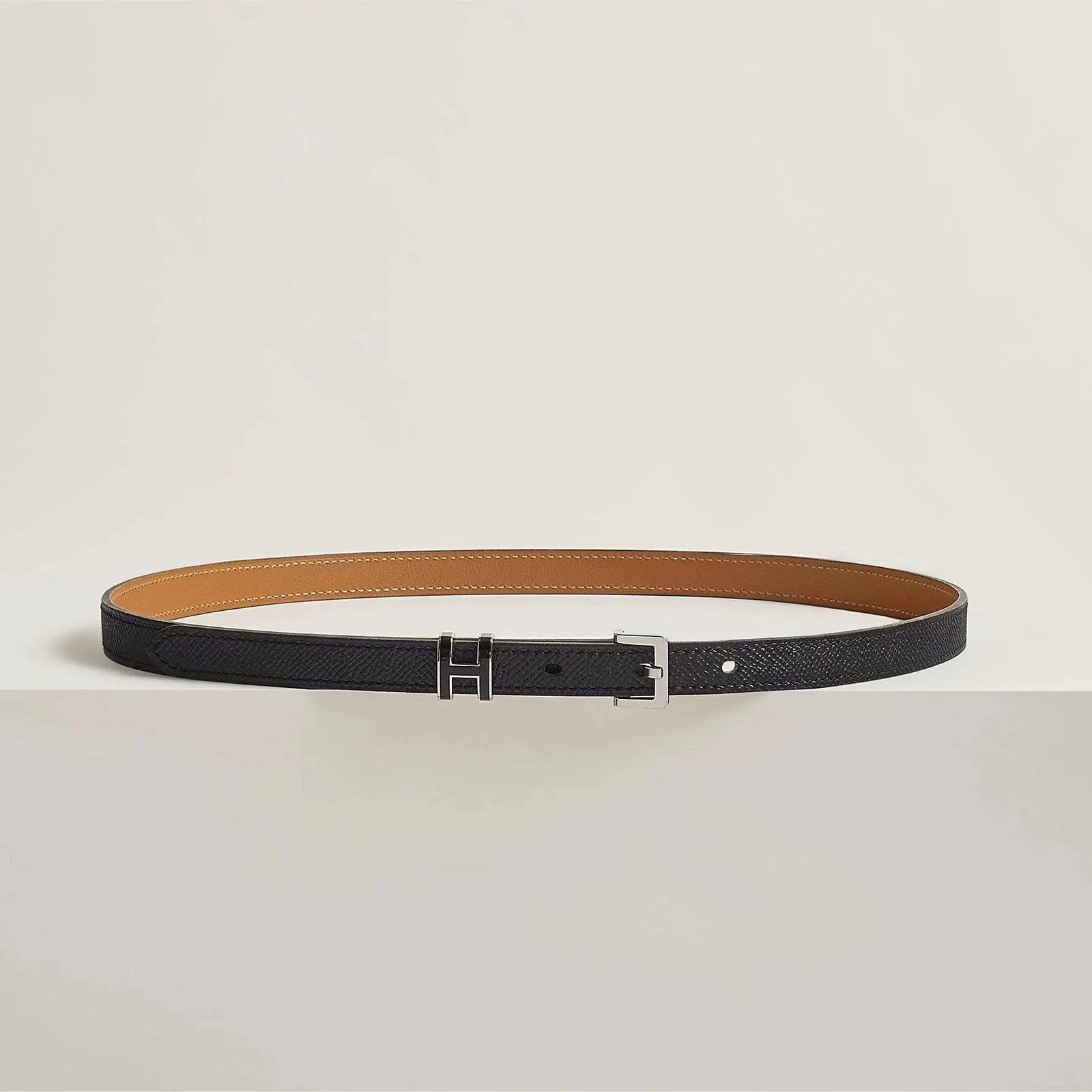 Premium Hermes leather belt with sleek metallic buckle, minimalist luxury accessory.