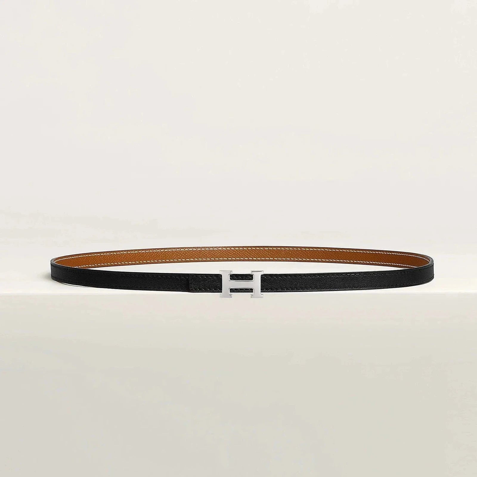 Luxury Hermes belt with sleek metallic buckle on premium leather.