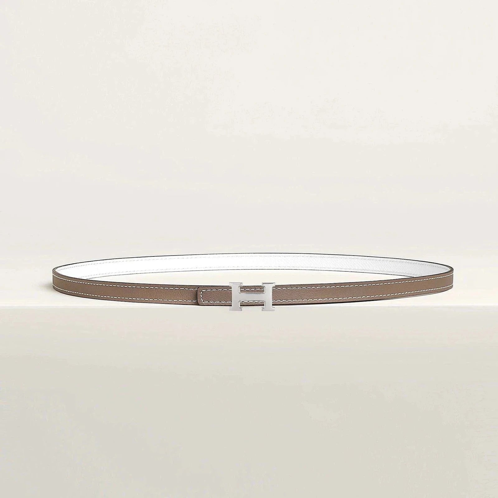 Image of Premium Hermes belt with minimalist design and elegant metallic buckle.