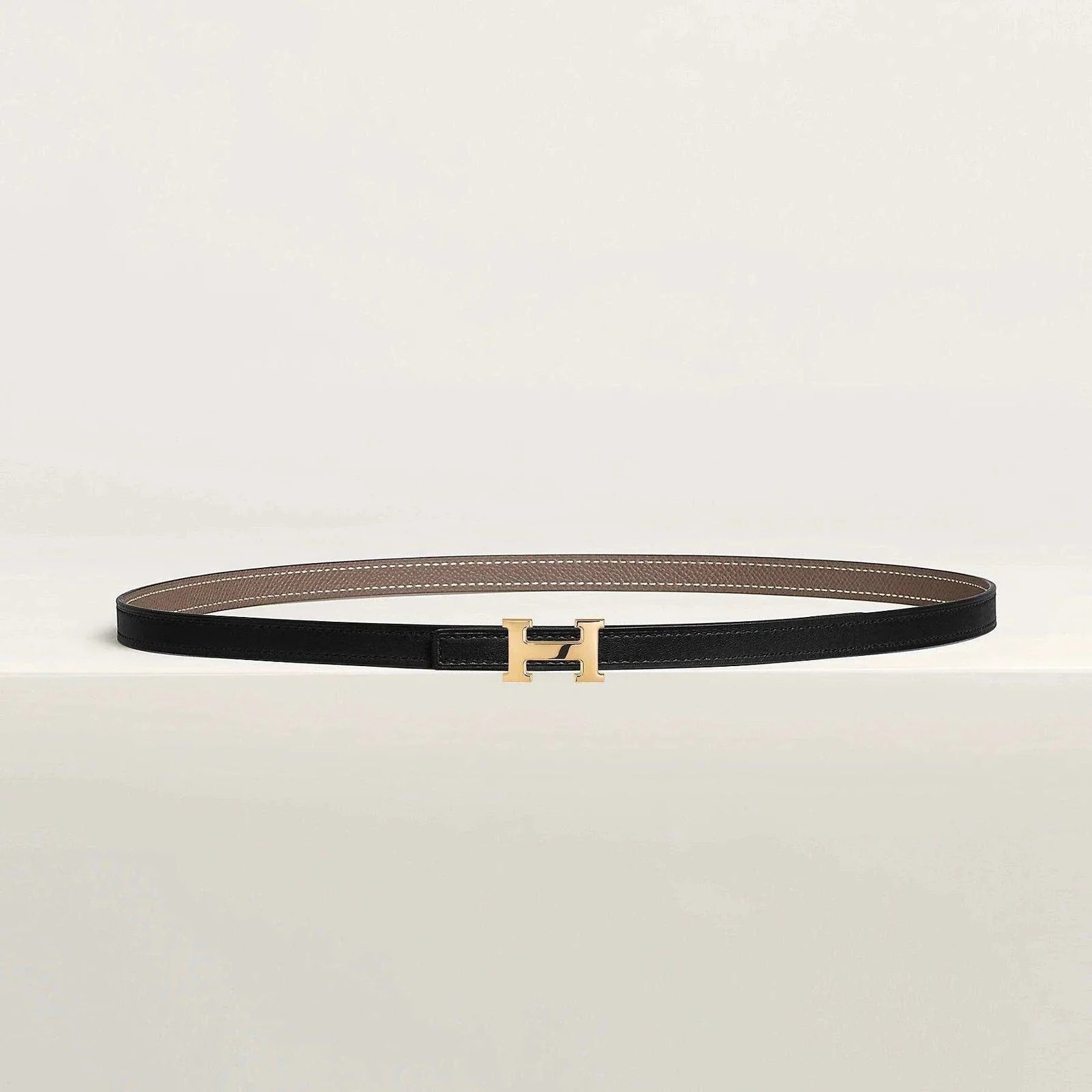 Image of Luxury Hermès belt with gold buckle and minimalist design, crafted from premium leather.