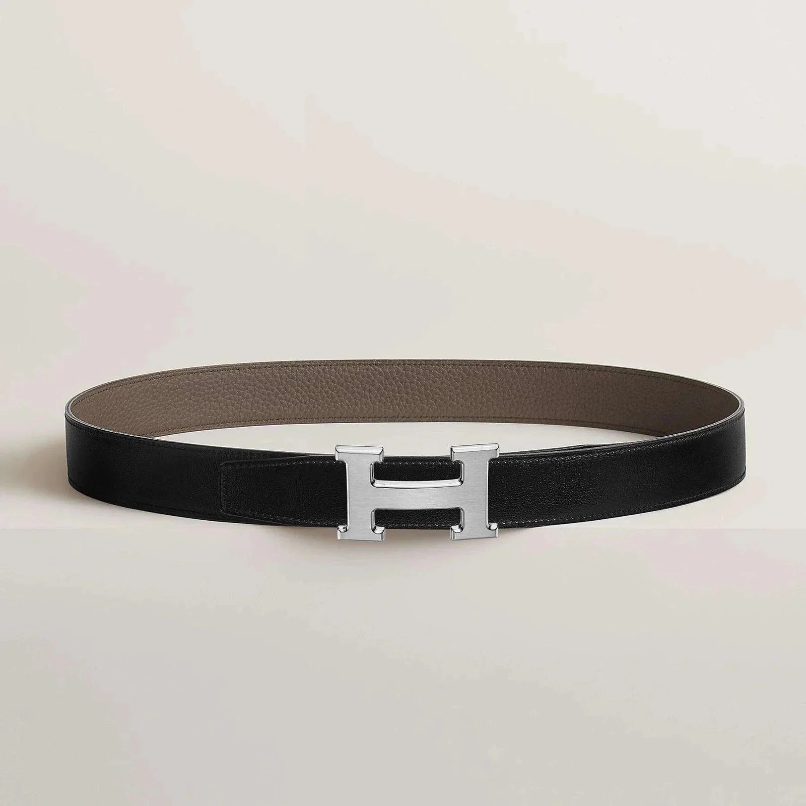 Hermes belt with elegant metallic buckle, premium leather, and minimalist design.