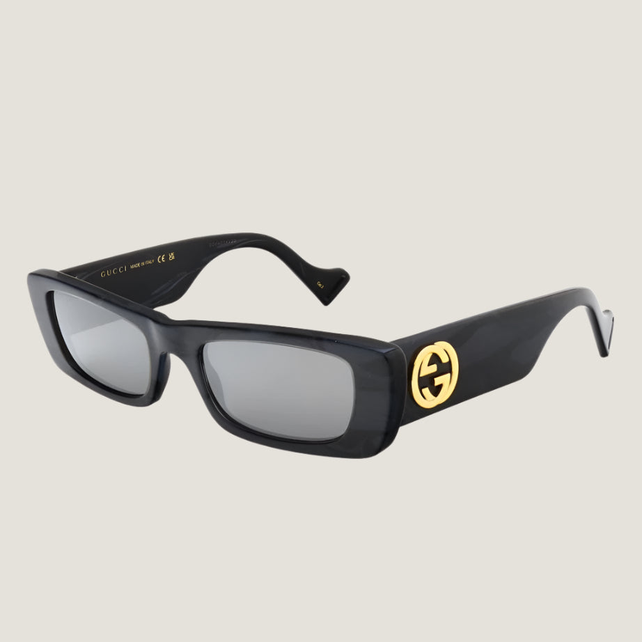 Gucci iconic luxury sunglasses with UV400 protection, stylish black frame, and gold logo.