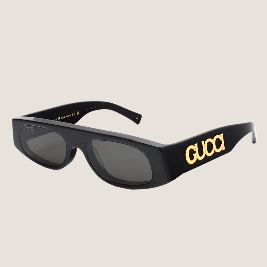 Gucci sunglasses with iconic luxury design, featuring bold black frames and gold logo detailing.
