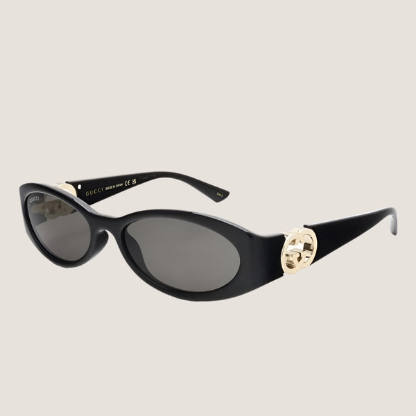 משקפי שמש GUCCI יוקרתיים עם מסגרת שחורה ועיטור זהב.