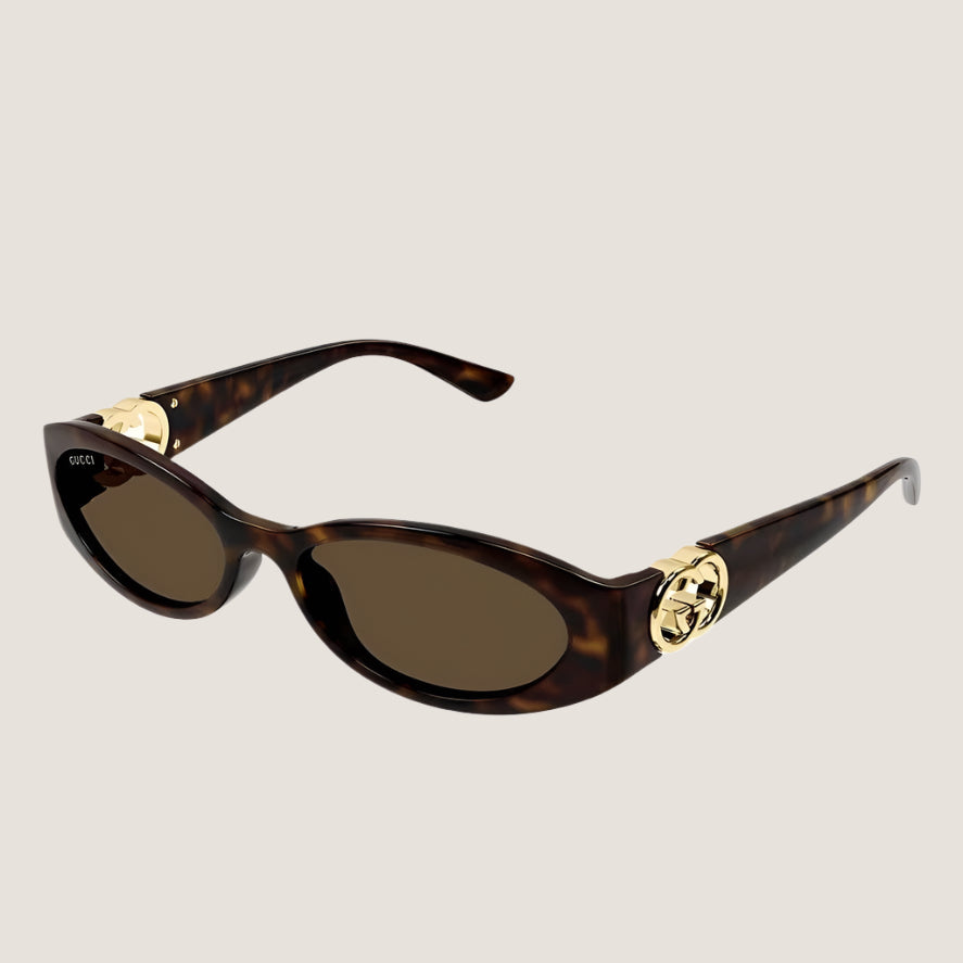 Image of Gucci sunglasses with tortoiseshell frames and gold accents, offering iconic style and UV400 protection.