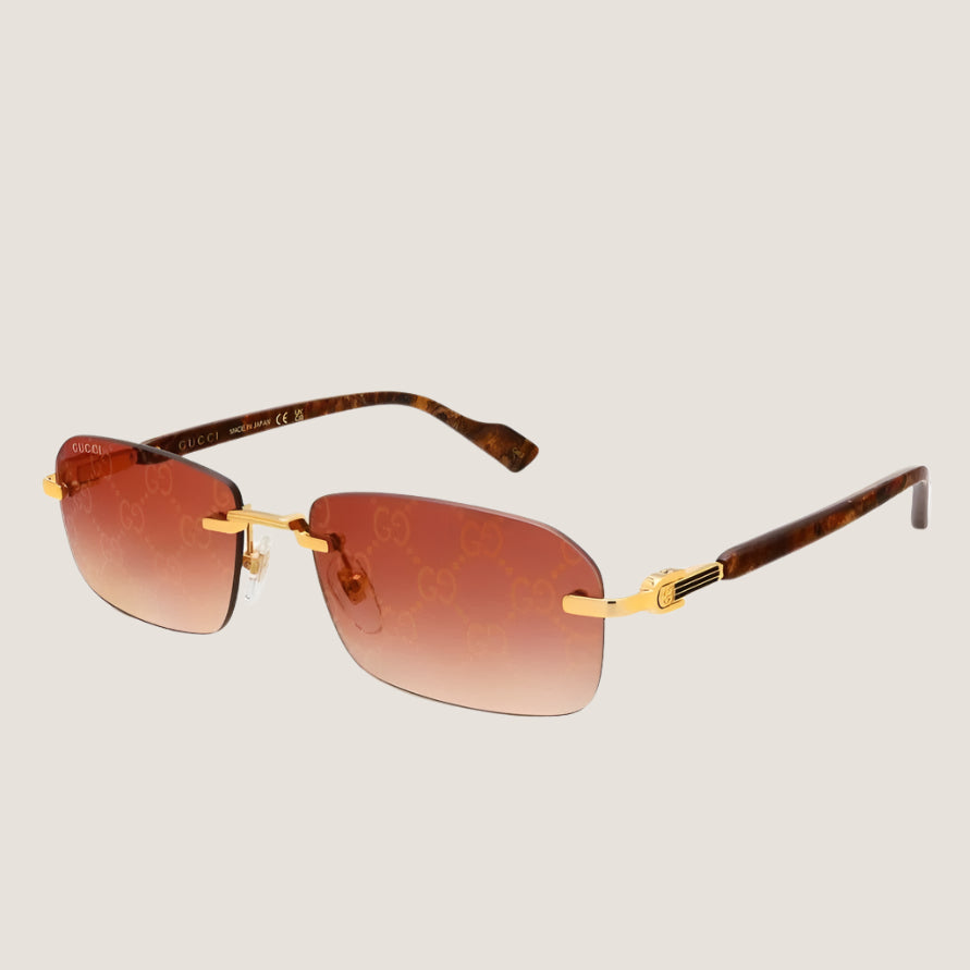 GUCCI iconic luxury sunglasses with gold accents and brown lenses.