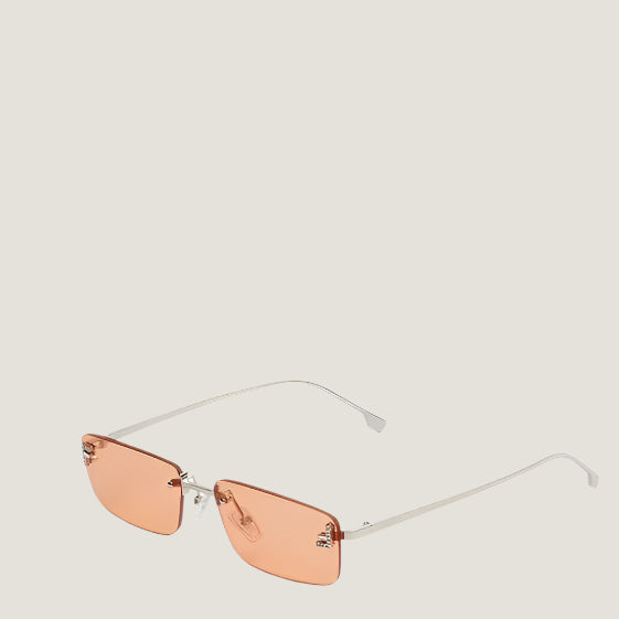 Fendi luxury Italian sunglasses with orange lenses and sleek metal frames.
