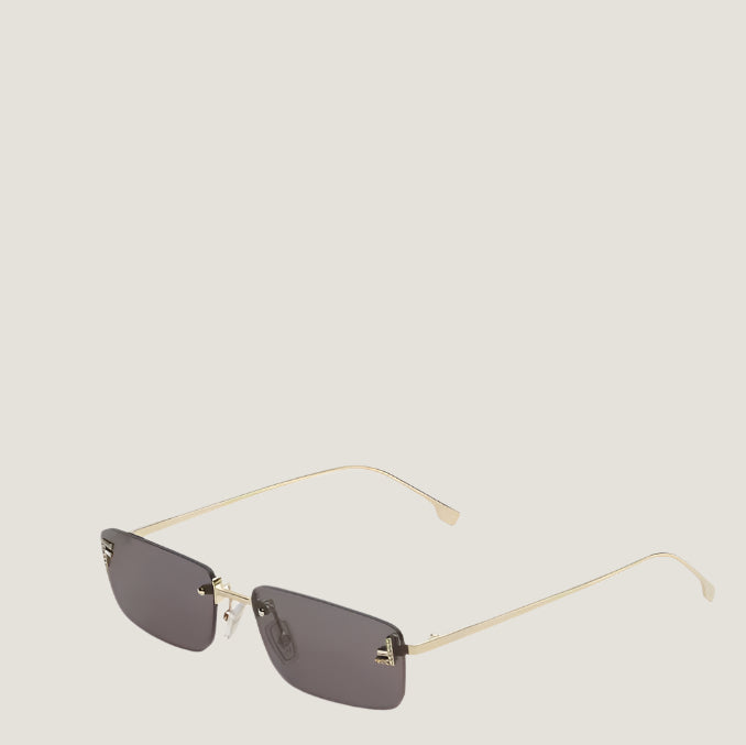 Image of Fendi sunglasses with gold frames and dark lenses, iconic Italian design.