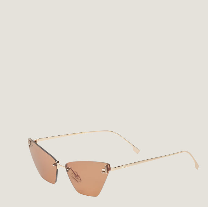 Image of Luxurious Fendi sunglasses with triangular lenses and gold frames.