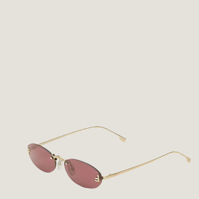 Image of Luxury Fendi sunglasses with gold frames and pink lenses, UV400 protection.