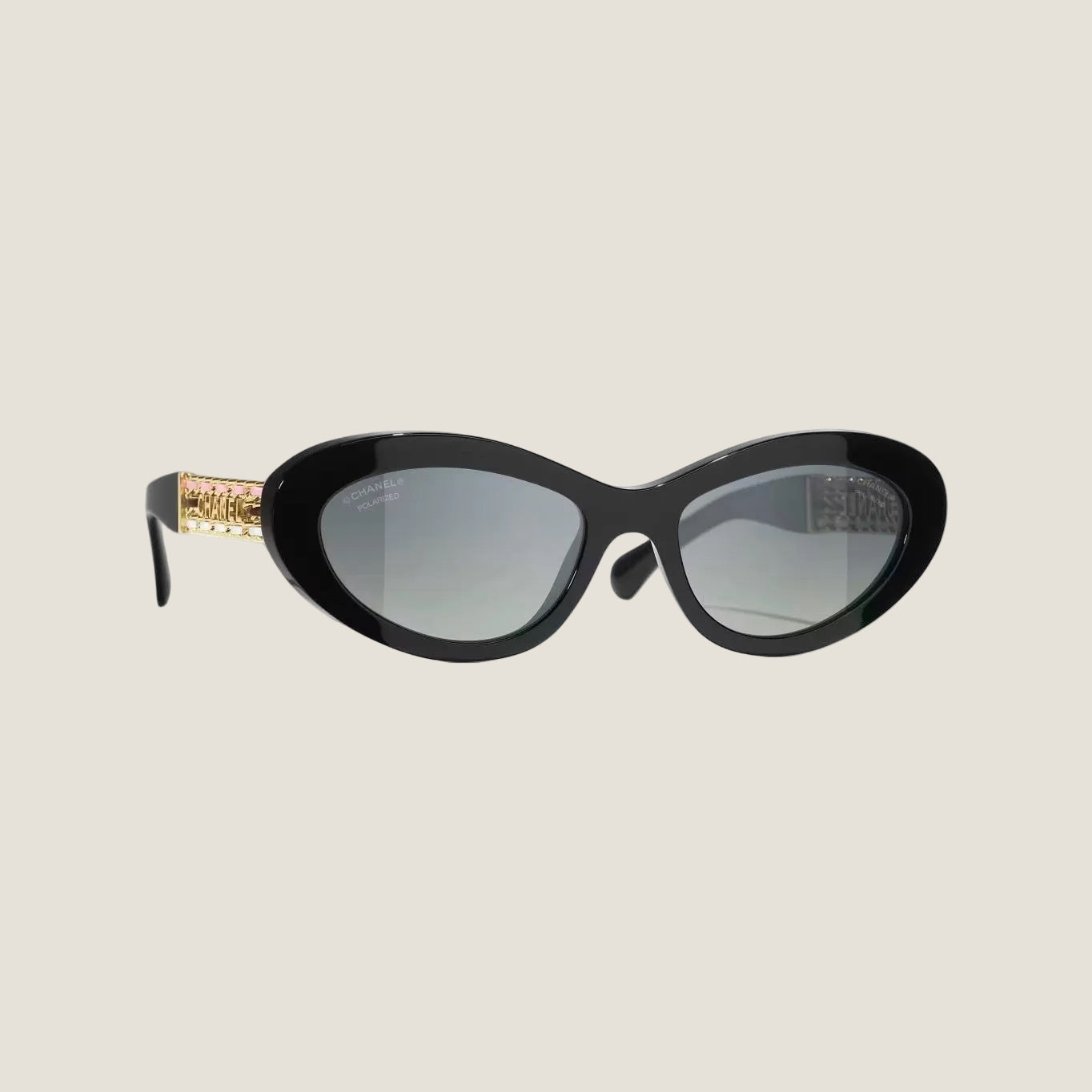 Image of CHANEL sunglasses with black and gold plastic frame, UVA/UVB protection.