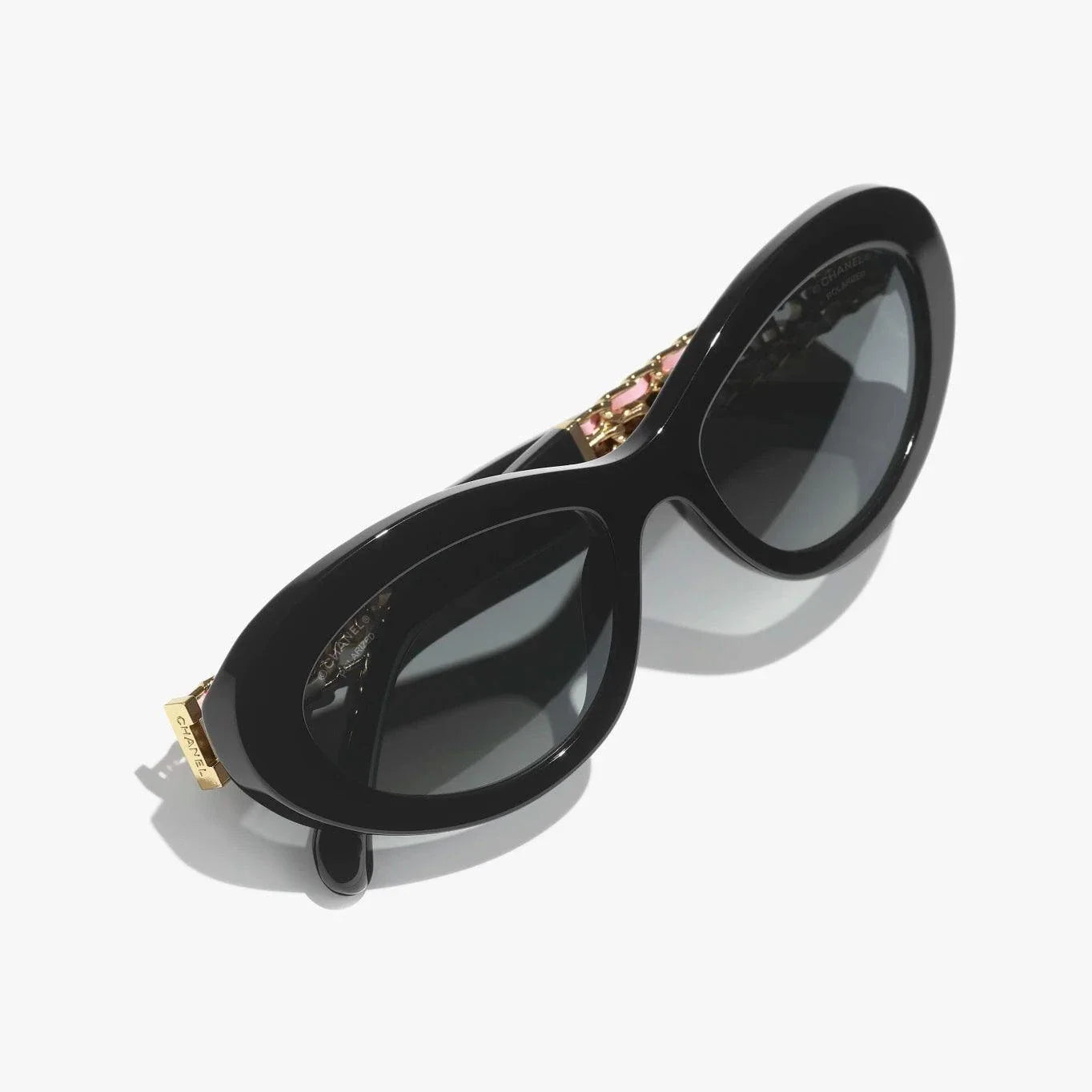 Image of CHANEL sunglasses with black and gold plastic frame, UVA/UVB protection.