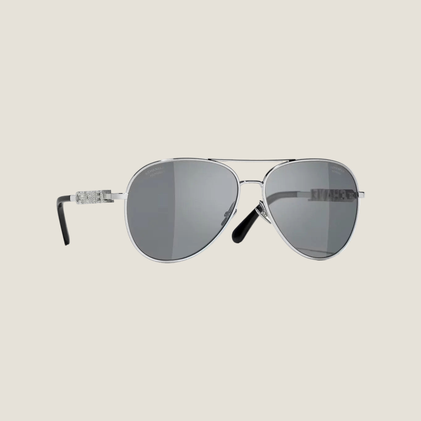 Silver CHANEL sunglasses with plastic frame, UVA/UVB protection, adjustable nose pads.