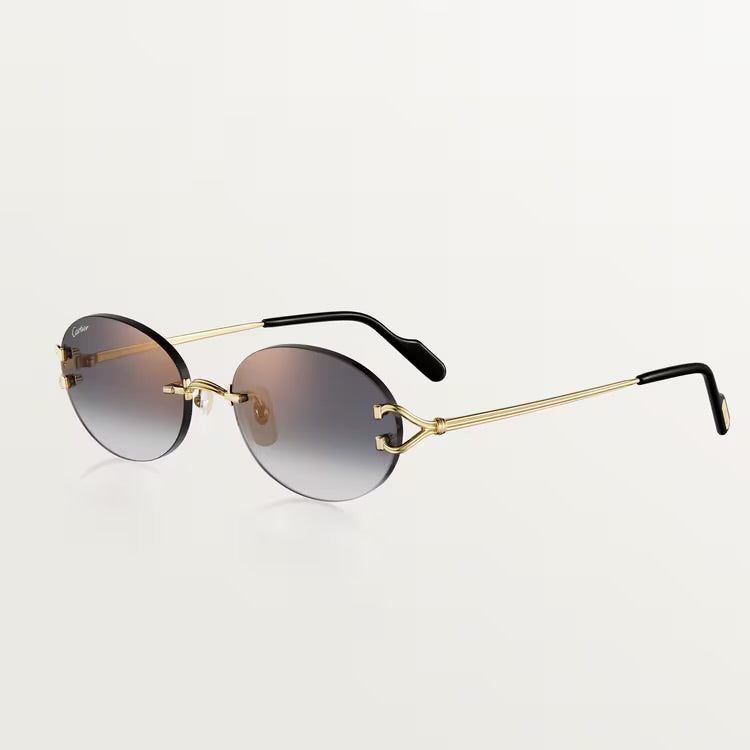 Image of Cartier gold sunglasses with metal frame, 100% UVA/UVB protection, adjustable nose pads, suitable for prescription lenses.