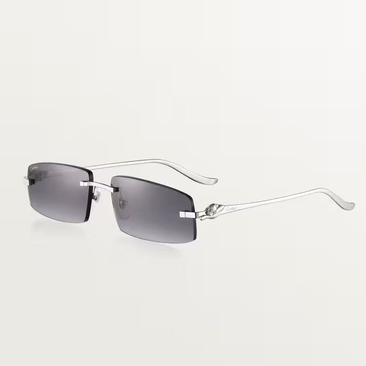 Image of Cartier silver sunglasses with metal frame and adjustable nose pads.