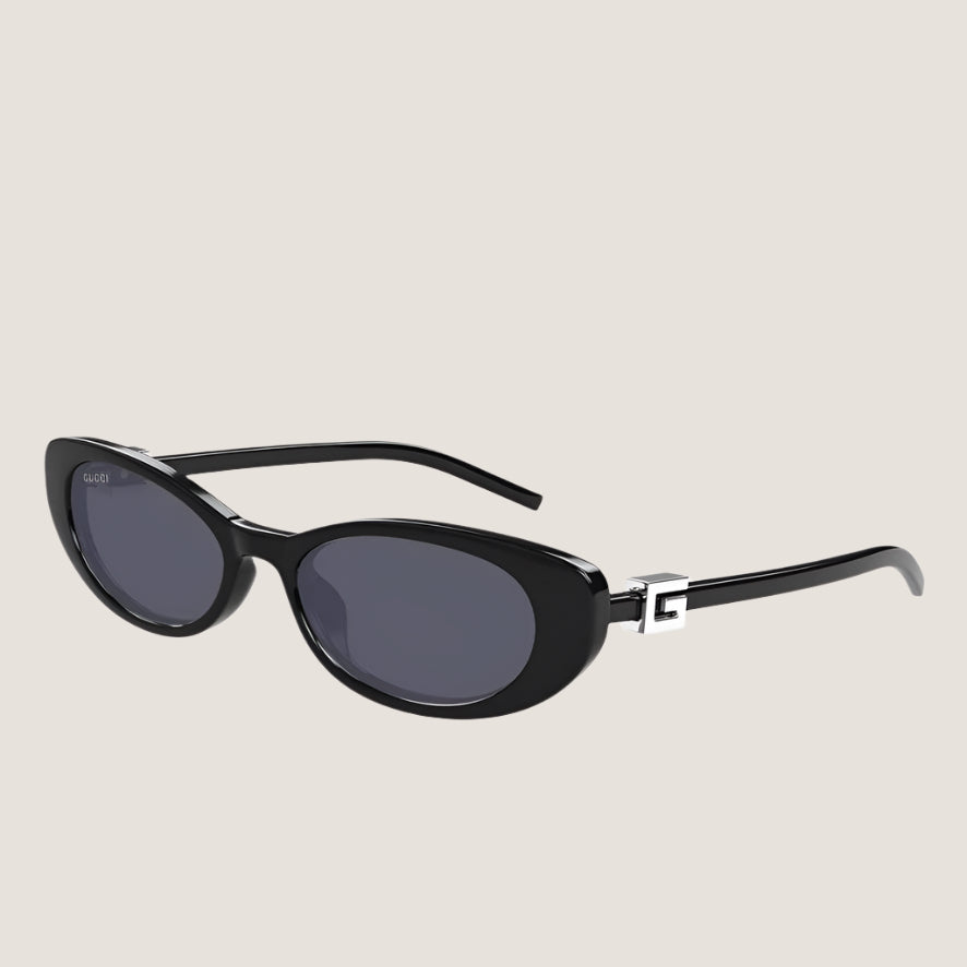 Image of Luxury Gucci sunglasses with sleek black frames and dark lenses.