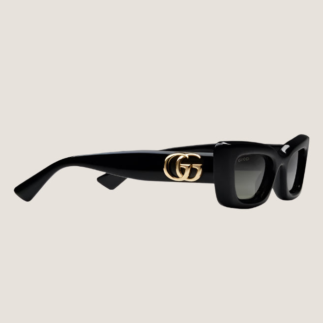 Image of GUCCI sunglasses with iconic GG branding and stylish black frames.