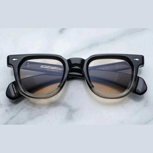 משקפי שמש Jacques Marie Mage Vendome בצבע שחור שקוף עם מסגרת פלסטיק והגנה מלאה מפני UVA/UVB.